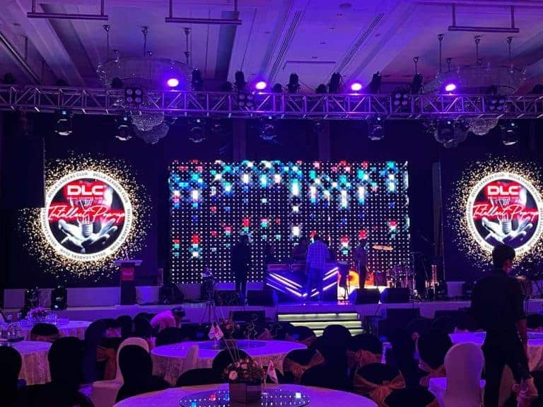 Vibrant stage setup with colorful lights and DLC Fashion Pop event branding, ready for a live performance.